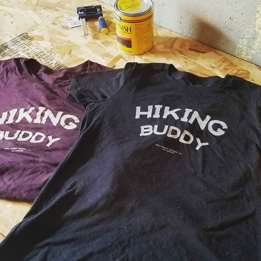 Hand screen-printed 'Hiking Buddy' tees in maroon and navy