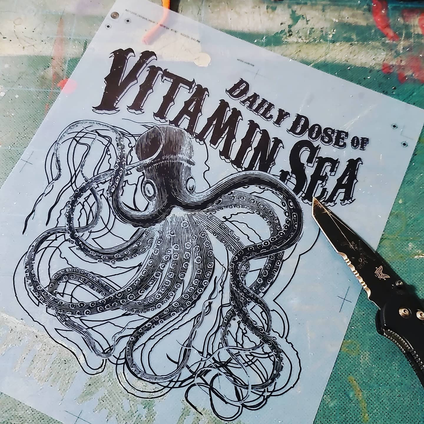 Hand-inked octopus screen-print film on the shop table