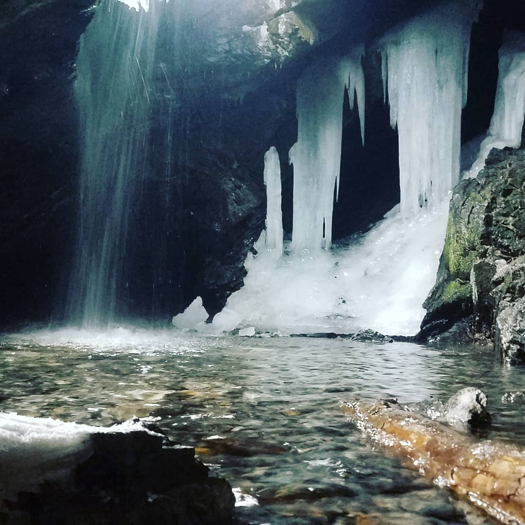 Behind a frozen waterfall in Donut Falls, Wasatch-Cache National Forest