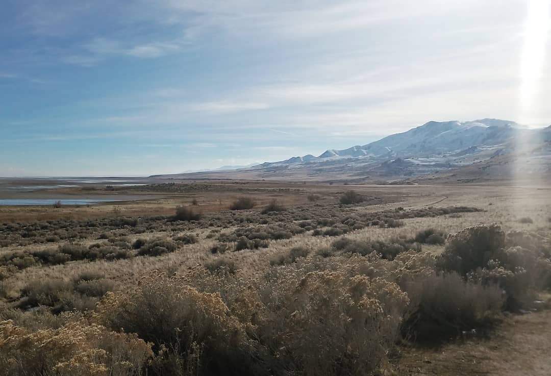 Sagebrush flats running out to a snow-topped range near the Great Salt Lake